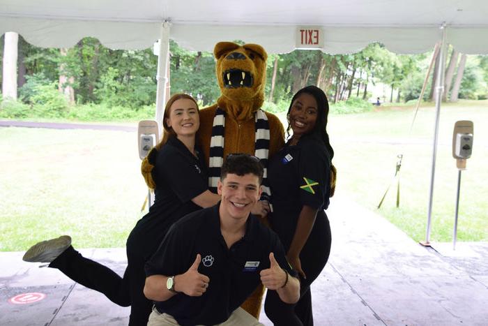 three students posing with Nittany Lion 